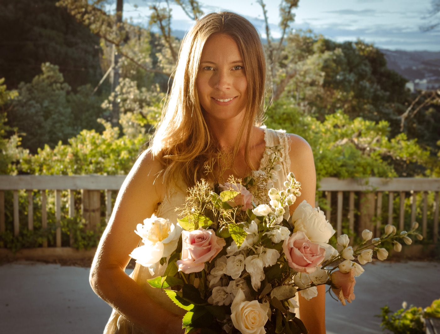 Bride holding a bouquet in golden light