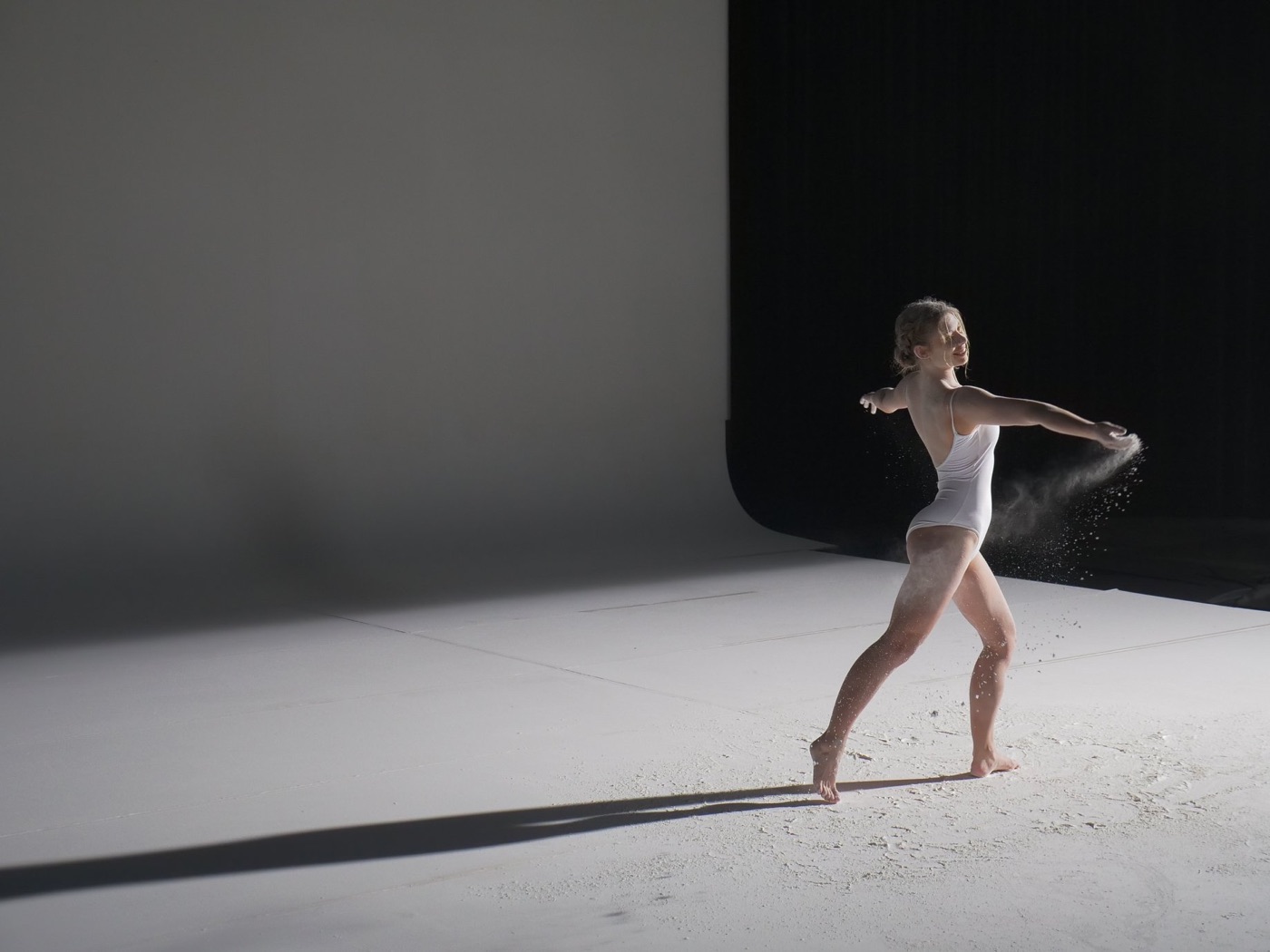 Small dancer on a vast white cyclorama