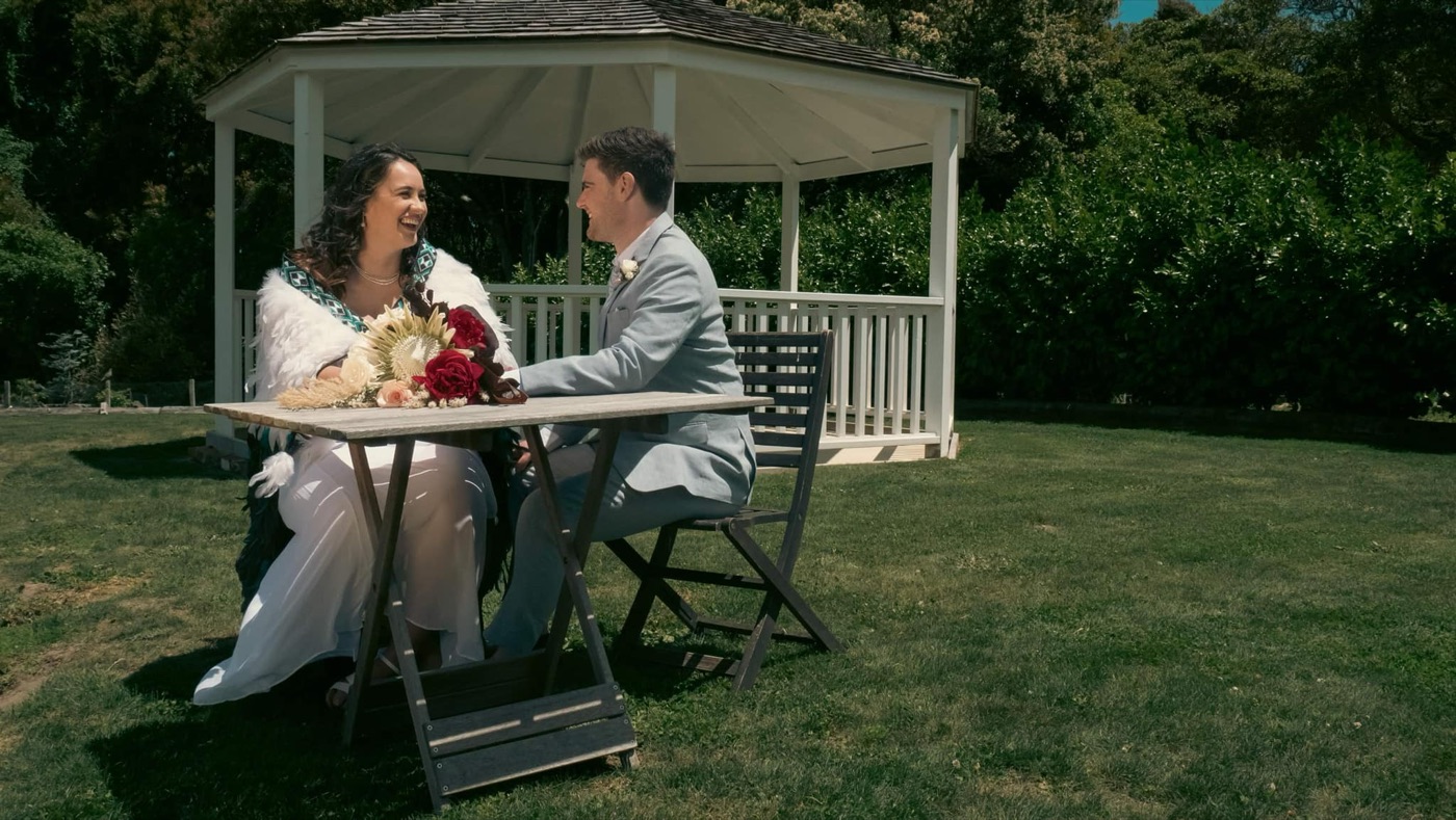 Couple seated beneath a garden gazebo