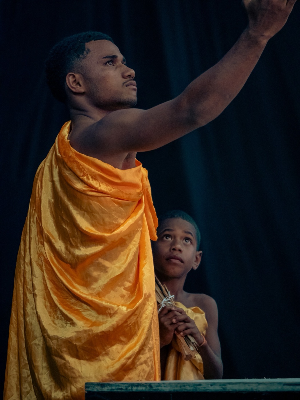 Child wrapped in orange cloth at a festival
