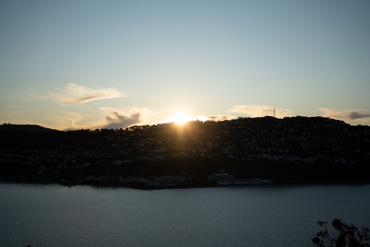 Sun setting over a lake and hills