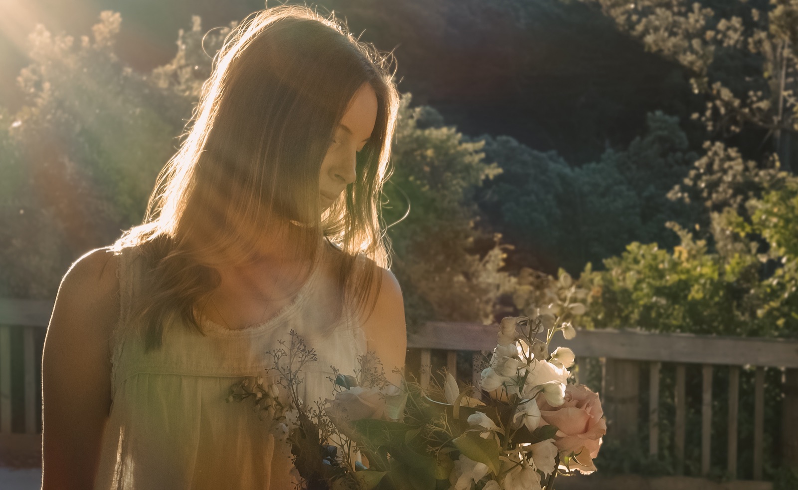 Florist holding a bouquet in golden backlight